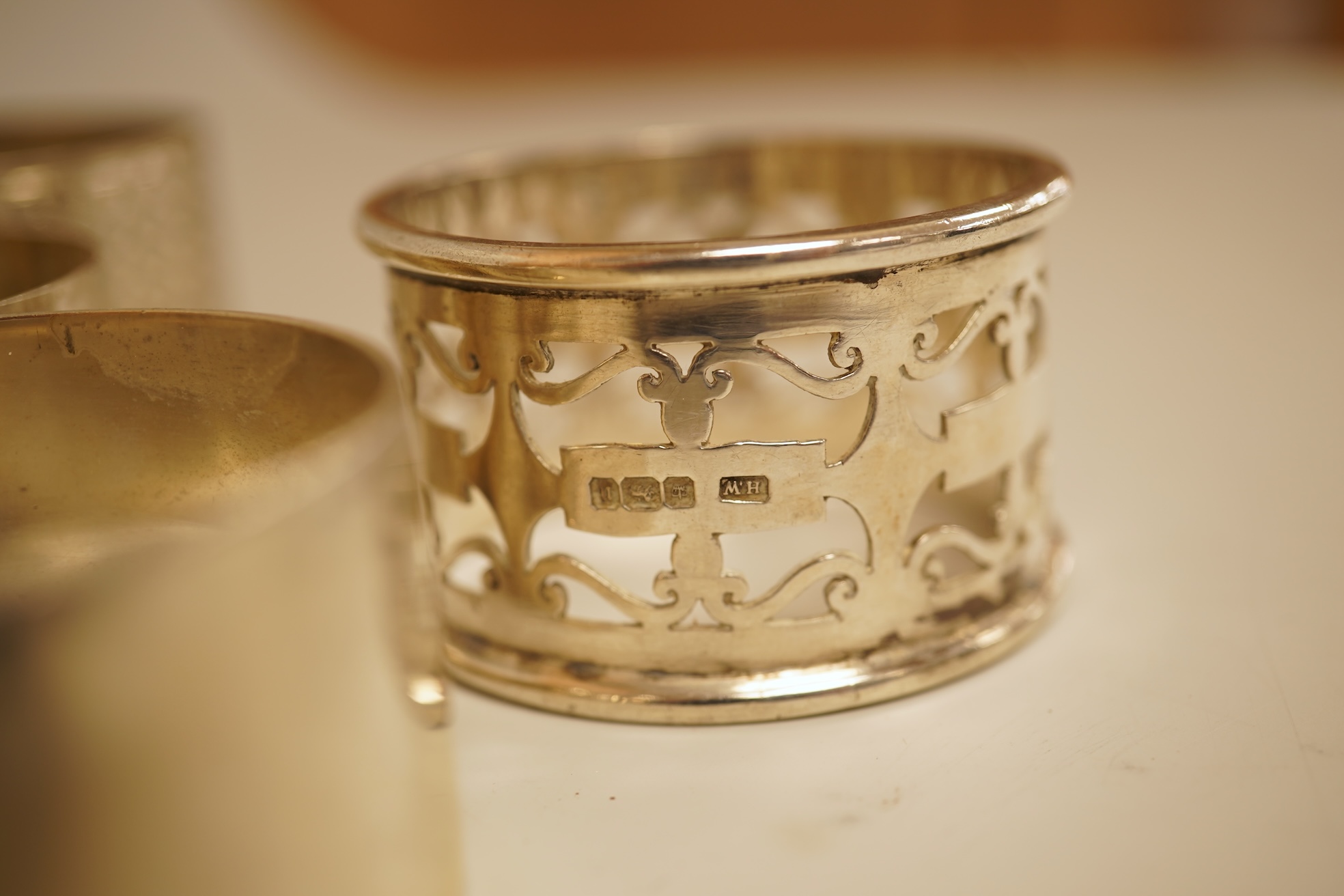 A pair of Edwardian pieced silver napkin rings by Henry Wigfull, Sheffield, 1905, together with nine other assorted silver napkin rings.